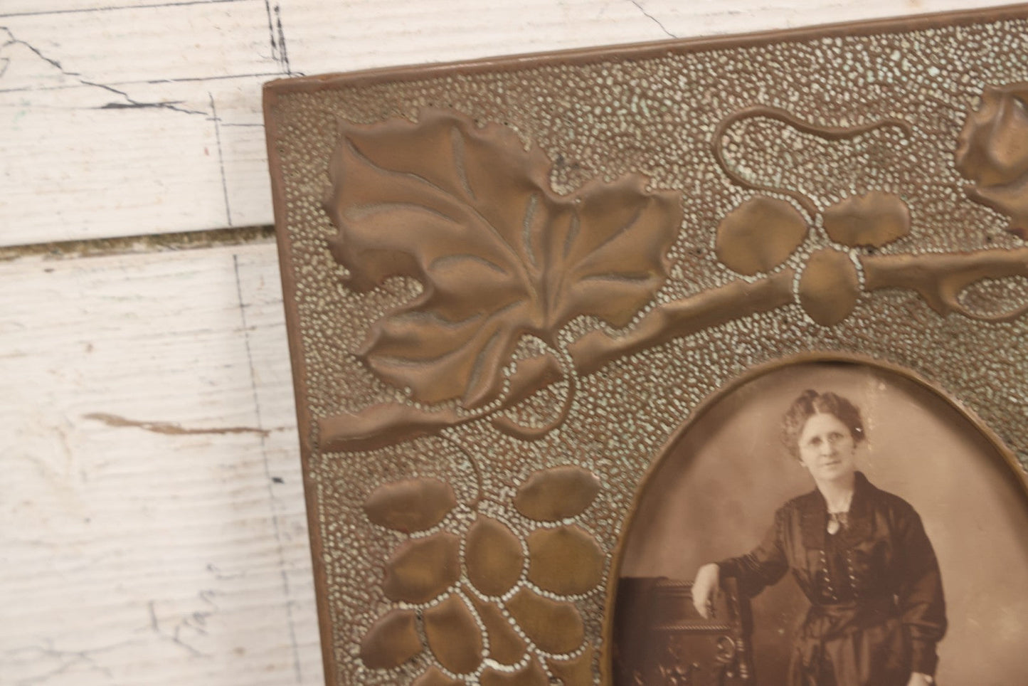 Lot 138 - Antique Hammered Brass Photo Frame With Grapes And Grape Leaves Motif, Missing Stand, 8-1/8" x 10"