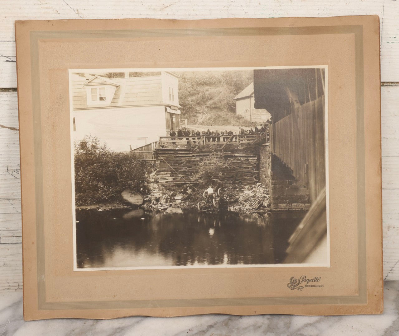Lot 143 - Antique Boarded Photograph Of Crowd Overlooking Car Accident Scene Above River, Recovery In Progress, Photographed By Paquette, Beecher Falls, Vermont, Circa 1920