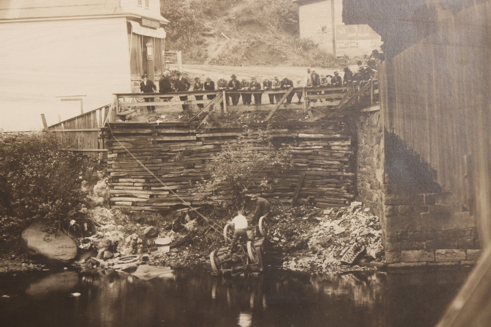 Lot 143 - Antique Boarded Photograph Of Crowd Overlooking Car Accident Scene Above River, Recovery In Progress, Photographed By Paquette, Beecher Falls, Vermont, Circa 1920