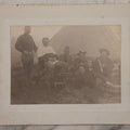 Lot 145 - Antique Boarded Photograph Of Soldiers Relaxing At Camp, Including Buglers And A Man Being Shaved, Posed Before Large Canvas Tent