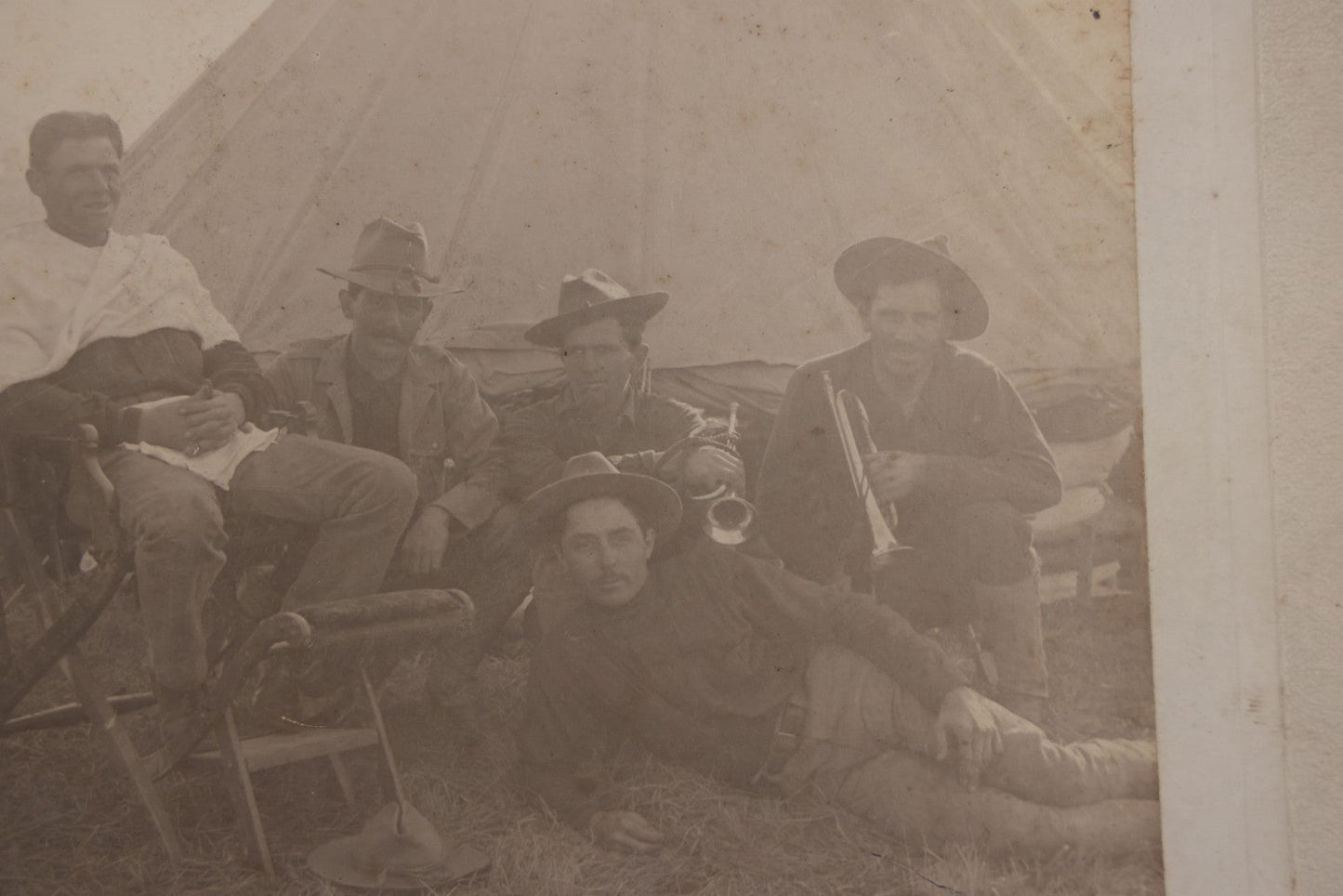 Lot 145 - Antique Boarded Photograph Of Soldiers Relaxing At Camp, Including Buglers And A Man Being Shaved, Posed Before Large Canvas Tent