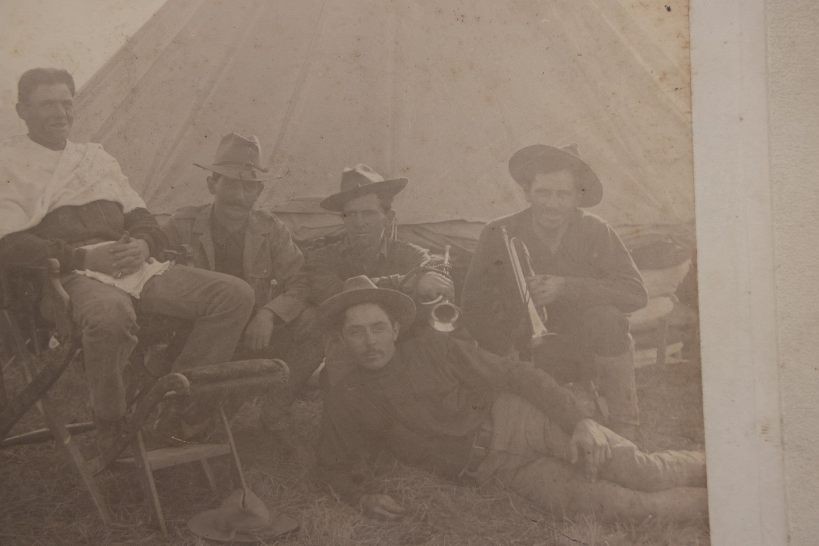 Lot 145 - Antique Boarded Photograph Of Soldiers Relaxing At Camp, Including Buglers And A Man Being Shaved, Posed Before Large Canvas Tent