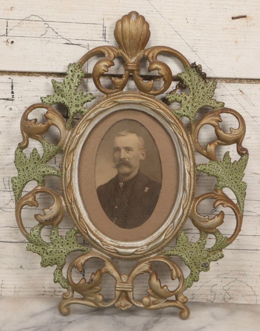Lot 152 - Antique Decorative Cast Metal Frame With Silver, Gold, And Green Paint And Oval Portrait Of Man With Mustache