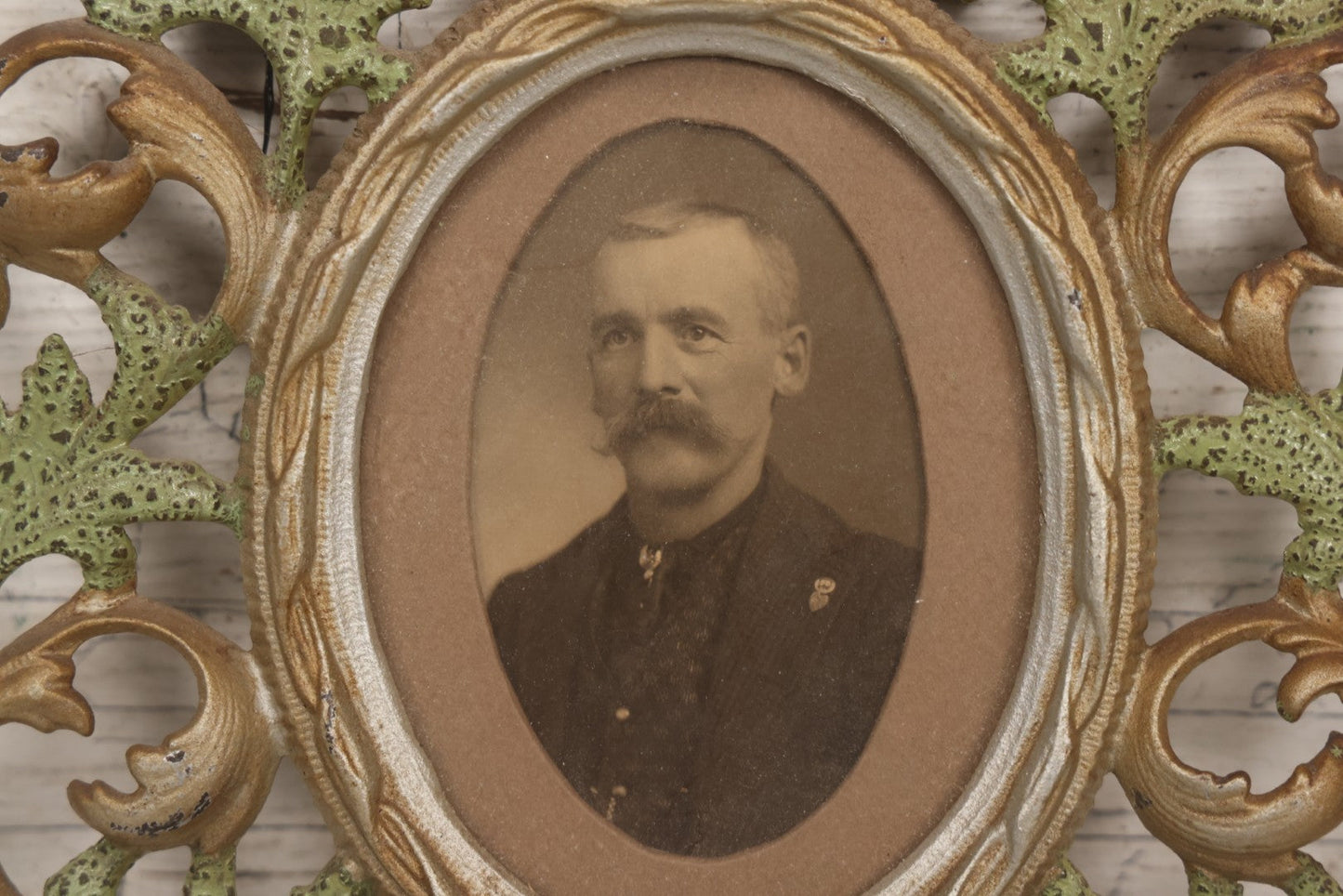 Lot 152 - Antique Decorative Cast Metal Frame With Silver, Gold, And Green Paint And Oval Portrait Of Man With Mustache