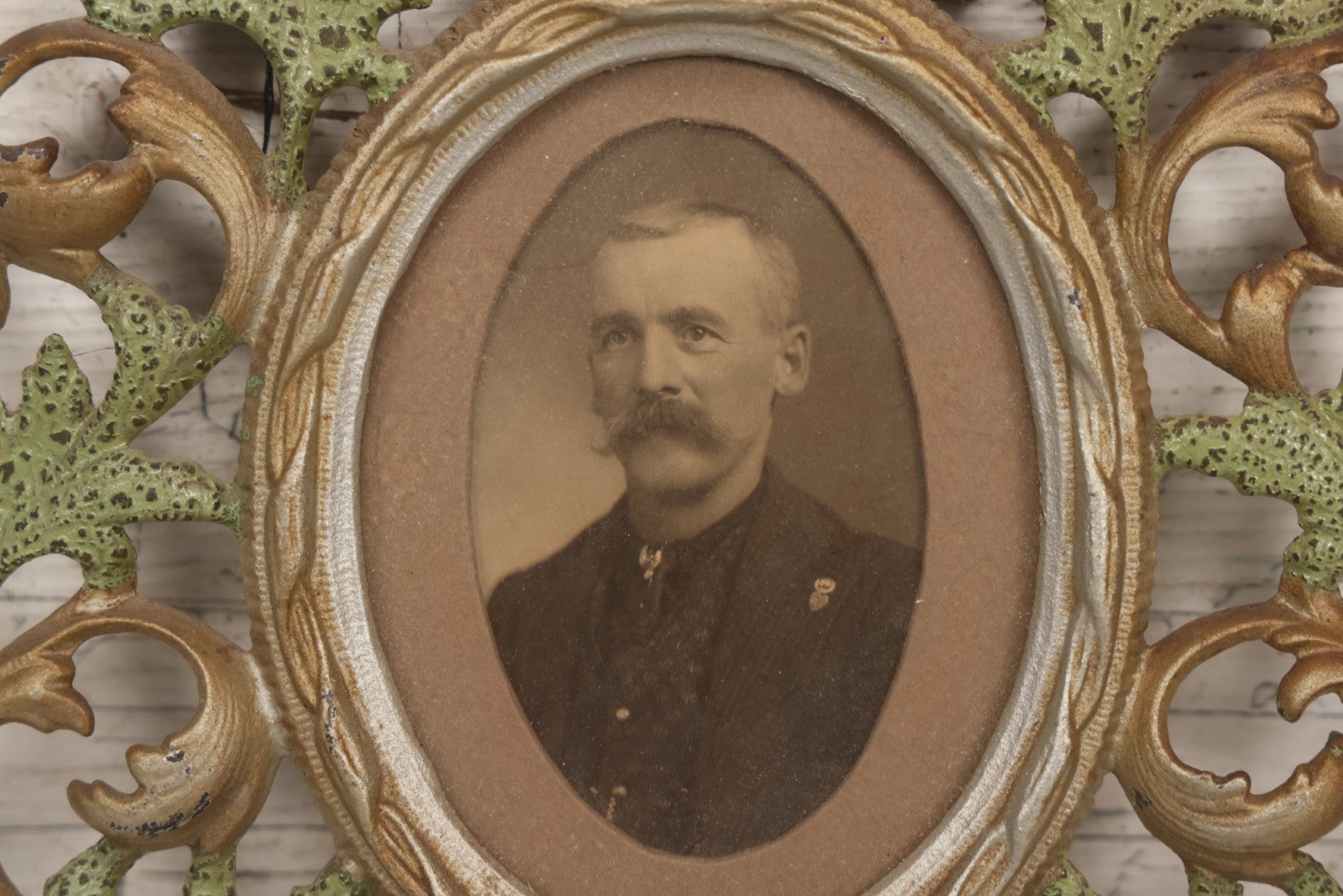 Lot 152 - Antique Decorative Cast Metal Frame With Silver, Gold, And Green Paint And Oval Portrait Of Man With Mustache