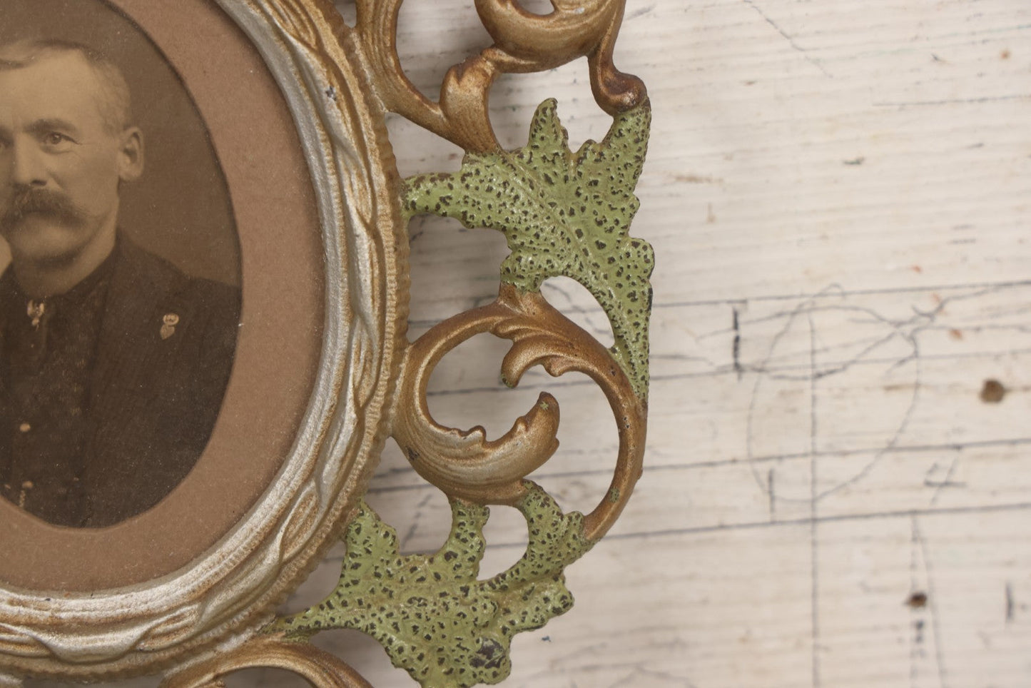 Lot 152 - Antique Decorative Cast Metal Frame With Silver, Gold, And Green Paint And Oval Portrait Of Man With Mustache