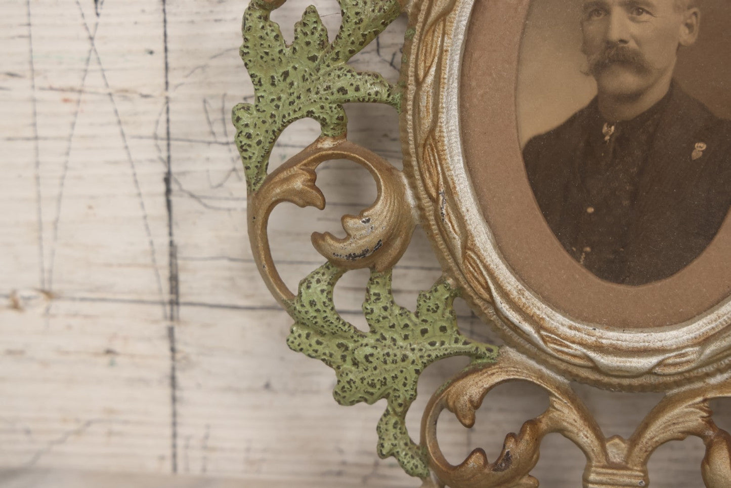 Lot 152 - Antique Decorative Cast Metal Frame With Silver, Gold, And Green Paint And Oval Portrait Of Man With Mustache