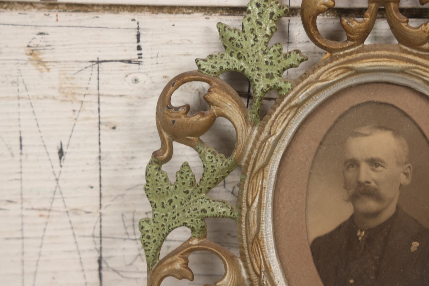 Lot 152 - Antique Decorative Cast Metal Frame With Silver, Gold, And Green Paint And Oval Portrait Of Man With Mustache