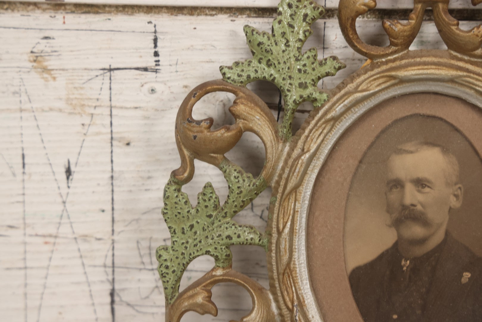 Lot 152 - Antique Decorative Cast Metal Frame With Silver, Gold, And Green Paint And Oval Portrait Of Man With Mustache