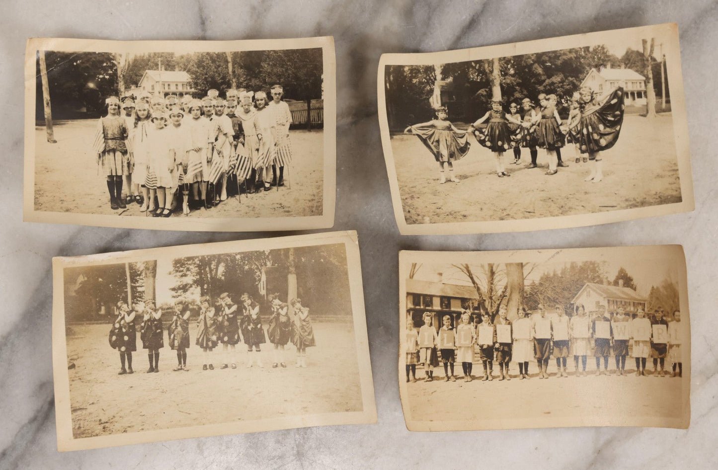 Lot 154 - Grouping Of Four Antique Snapshots Of Schoolchildren In Costume, Including Halloween Dress, Patriotic Headbands With Flags, And Children Holding Letter Signs