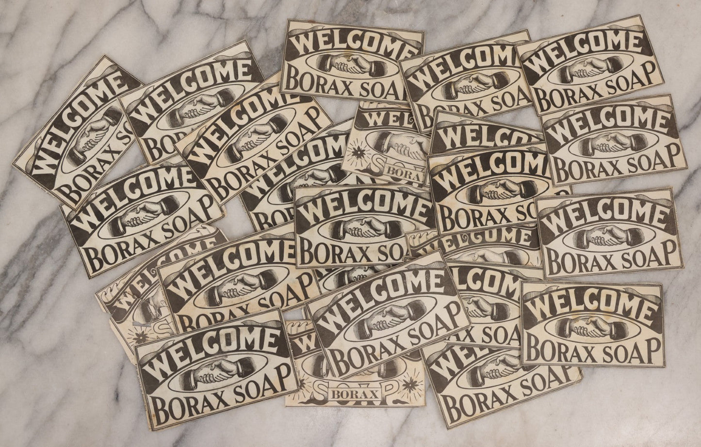 Lot 170 - Grouping Of 20+ Vintage Borax Soap “Welcome” Coupon Cut-Outs With Handshake Motif, Likely Premium/Redemption Slips On Thin Newsprint
