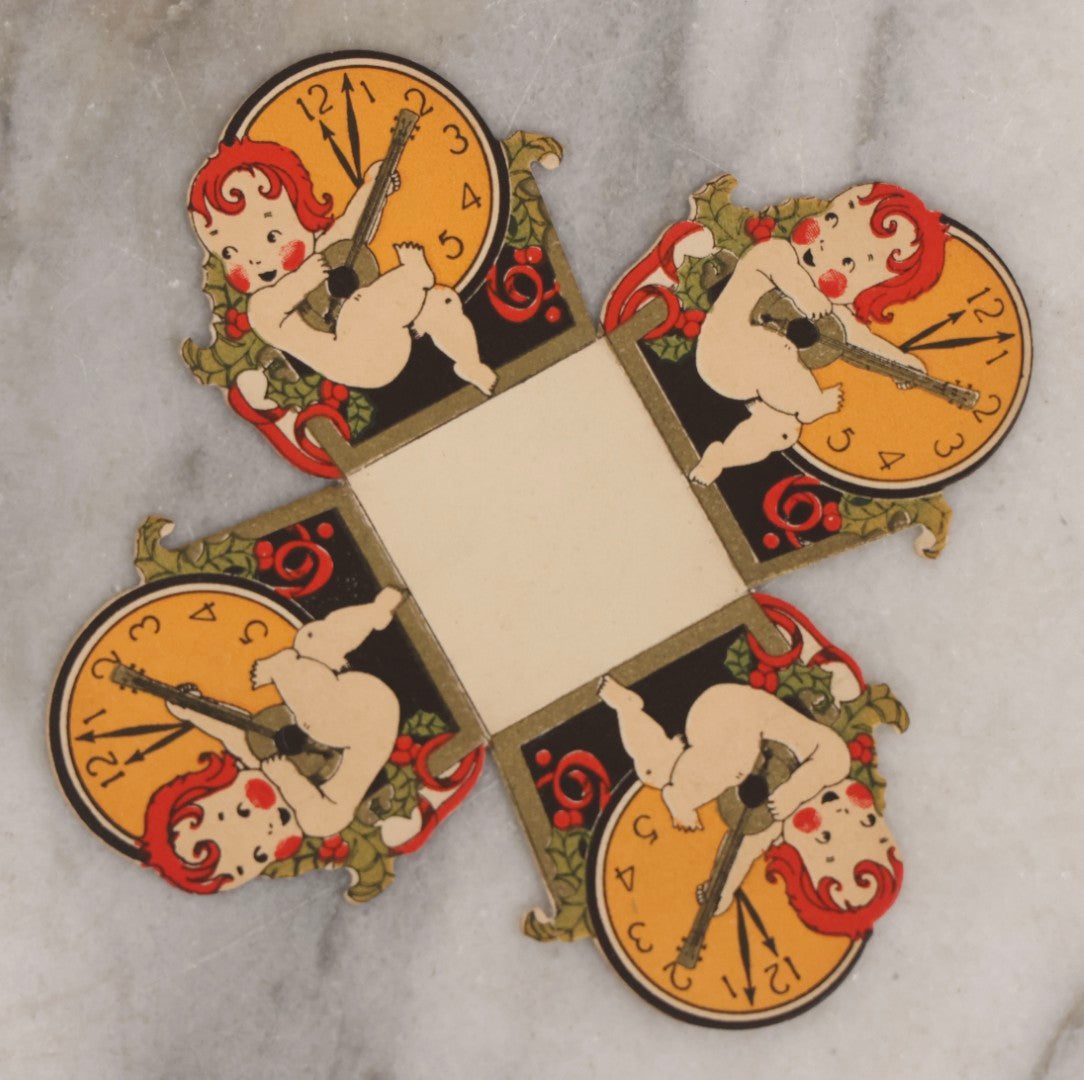 Lot 175 - Antique New Year's Eve Folding Paper Nut Cup With Cherub Playing Lute, By Gibson, U.S.A..