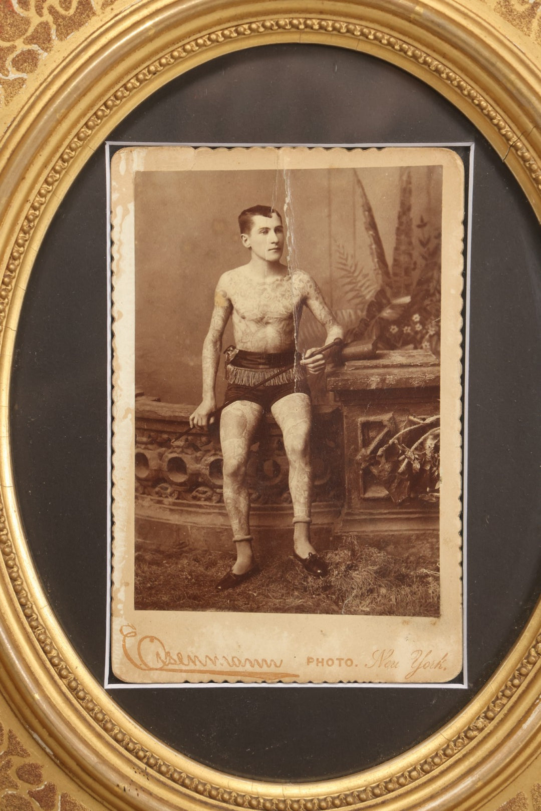 Lot 001 - Antique Cabinet Card Photograph Of Thomas Sidonia “The Tattooed Boy” At Age 21, Photographed By Charles Eisenmann, New York, Custom Framed With Visible Verso Inscription And Clear View Of Early American Traditional Tattoos, 13" x 15"