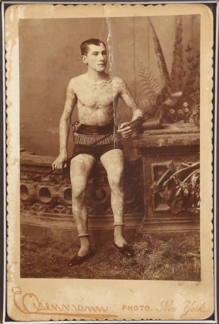 Lot 001 - Antique Cabinet Card Photograph Of Thomas Sidonia “The Tattooed Boy” At Age 21, Photographed By Charles Eisenmann, New York, Custom Framed With Visible Verso Inscription And Clear View Of Early American Traditional Tattoos, 13" x 15"