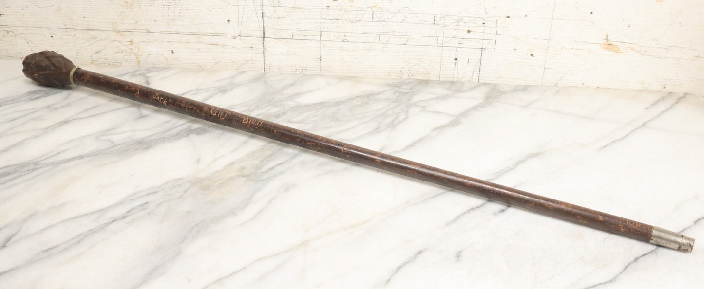 Lot 003 - Vintage Hand-Carved White Mountains, New Hampshire Folk Art Hiking Stick With Double-Sided Old Man Of The Mountain Carved Handle And Decades Of Carved Initials, Names, And Nicknames, 36" L