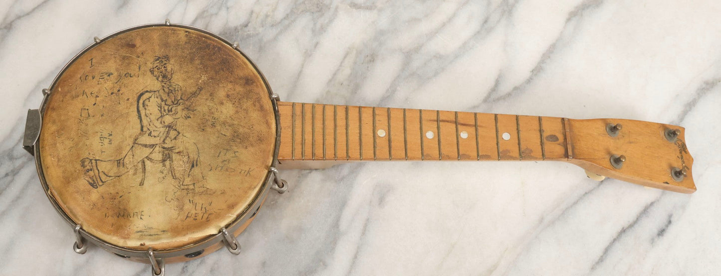 Lot 006 - Vintage Gretsch Clarophone Banjo Ukulele Banjolele With Folk Art Drawing On Head Of Cartoon Man Playing Instrument, Includes Canvas Carrying Bag, Circa 1930s