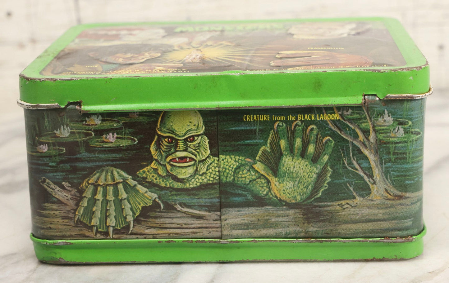 Lot 008 - Vintage Universal Movie Monsters Aladdin Brand Tin Lithograph Lunchbox Featuring Count Dracula, Wolf Man, Frankenstein, Mummy, Phantom Of The Opera, Creature From The Black Lagoon, Copyright 1979, Aladdin Industries Inc., Nashville, Tennessee