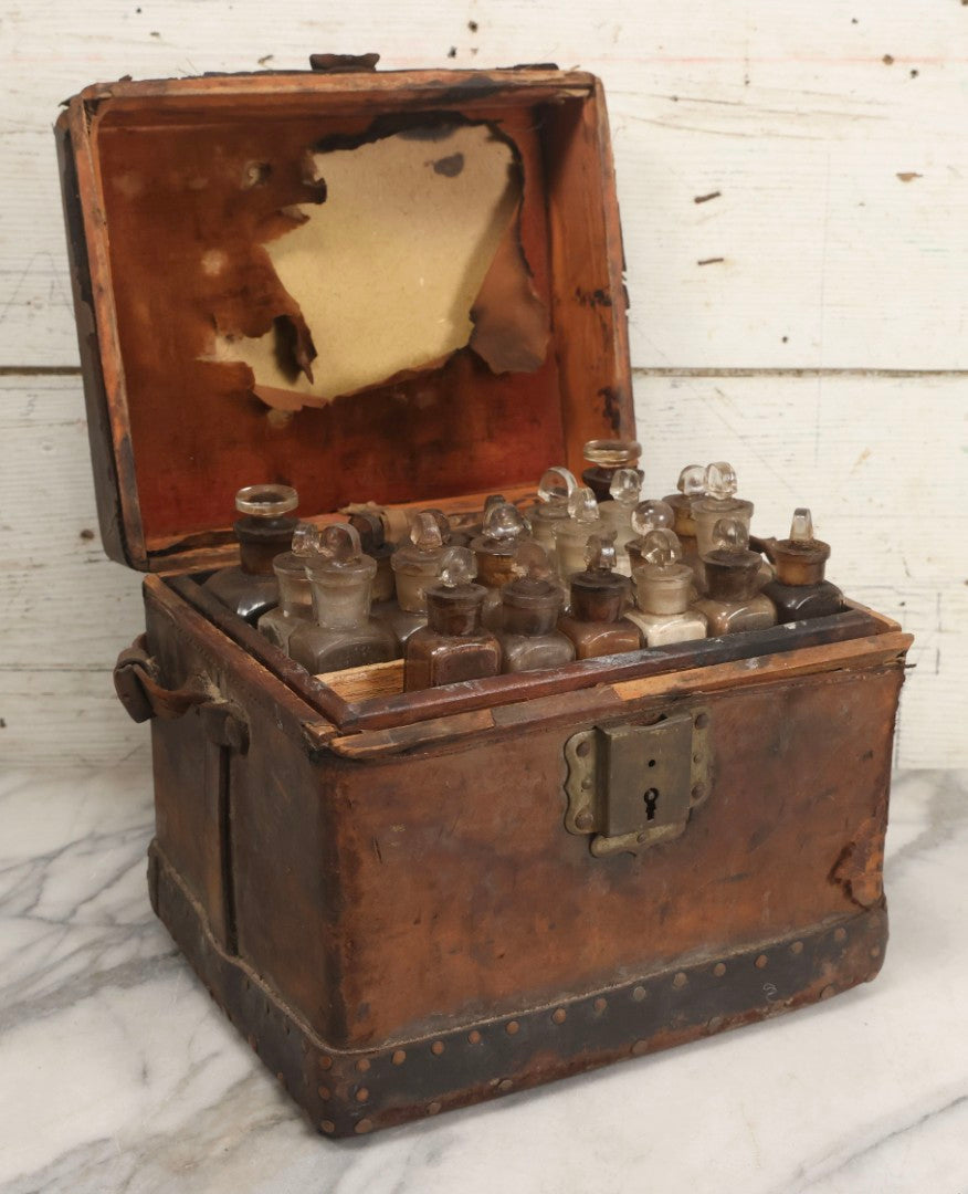 Lot 017 - Antique 19th Century Traveling Apothecary Kit In Leather-Wrapped Wood Box Stamped “Hoff's Patent, March 27, 1883,” With 20+ Glass Medicine Bottles And Internal Till