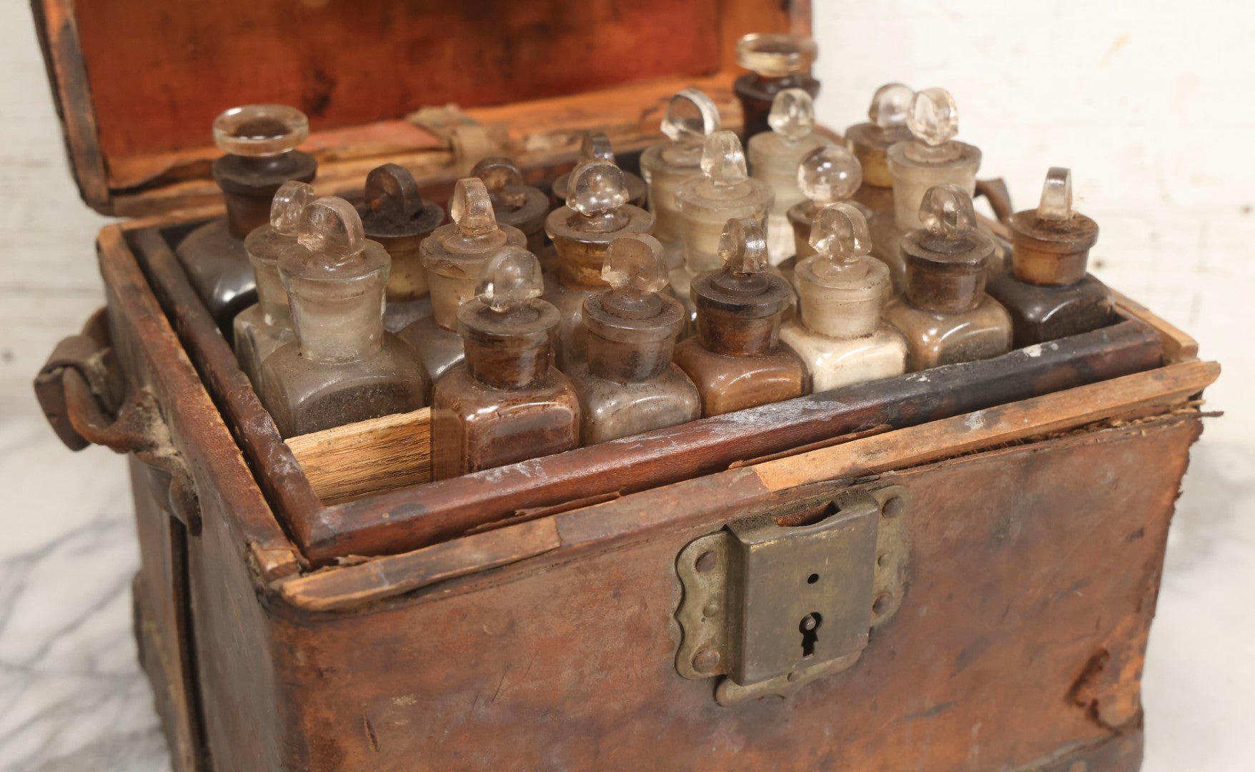 Lot 017 - Antique 19th Century Traveling Apothecary Kit In Leather-Wrapped Wood Box Stamped “Hoff's Patent, March 27, 1883,” With 20+ Glass Medicine Bottles And Internal Till