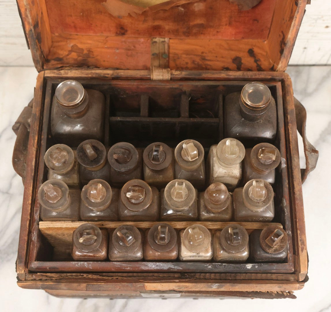 Lot 017 - Antique 19th Century Traveling Apothecary Kit In Leather-Wrapped Wood Box Stamped “Hoff's Patent, March 27, 1883,” With 20+ Glass Medicine Bottles And Internal Till