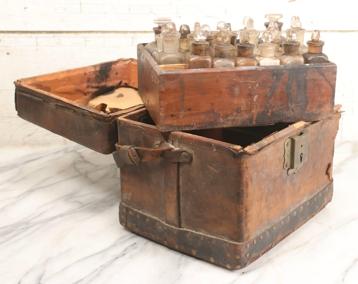 Lot 017 - Antique 19th Century Traveling Apothecary Kit In Leather-Wrapped Wood Box Stamped “Hoff's Patent, March 27, 1883,” With 20+ Glass Medicine Bottles And Internal Till