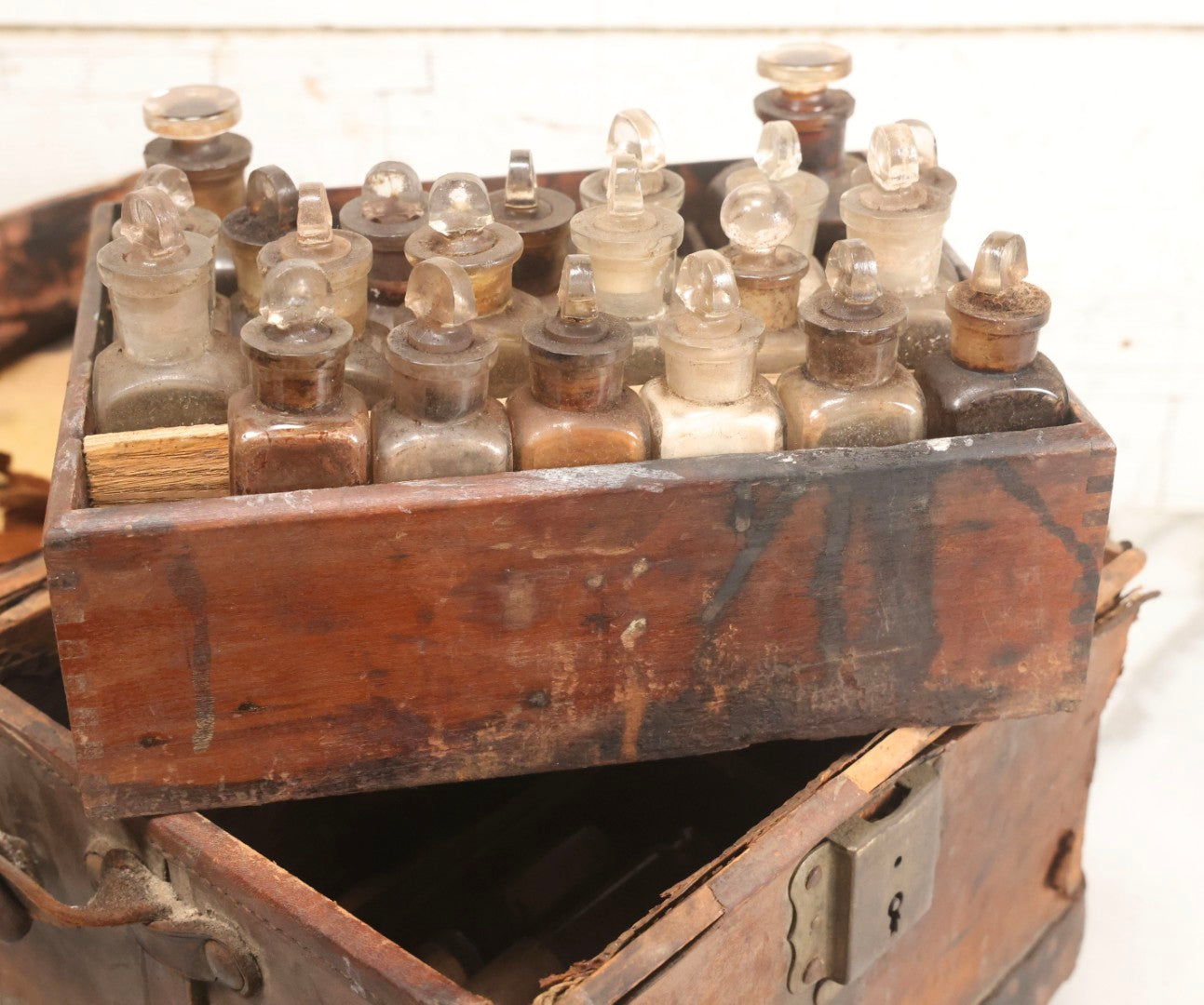 Lot 017 - Antique 19th Century Traveling Apothecary Kit In Leather-Wrapped Wood Box Stamped “Hoff's Patent, March 27, 1883,” With 20+ Glass Medicine Bottles And Internal Till