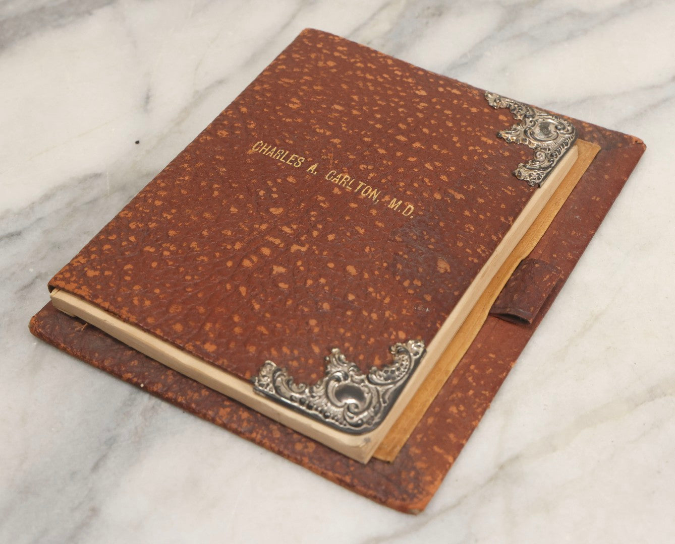 Lot 019 - Antique Leather-Covered Prescription Pad Belonging To Charles A. Carlton, M.D., Salem, Massachusetts, With Decorative Sterling Silver Corners And Unused Prescription Paper