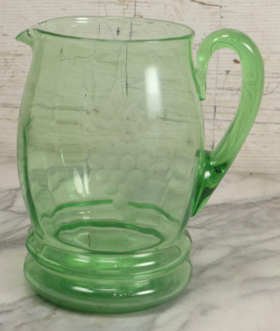 Lot 022 - Antique Uranium Glass Pitcher With Etched Grape Motif, Glows Under Blacklight, Note Chip On Spout