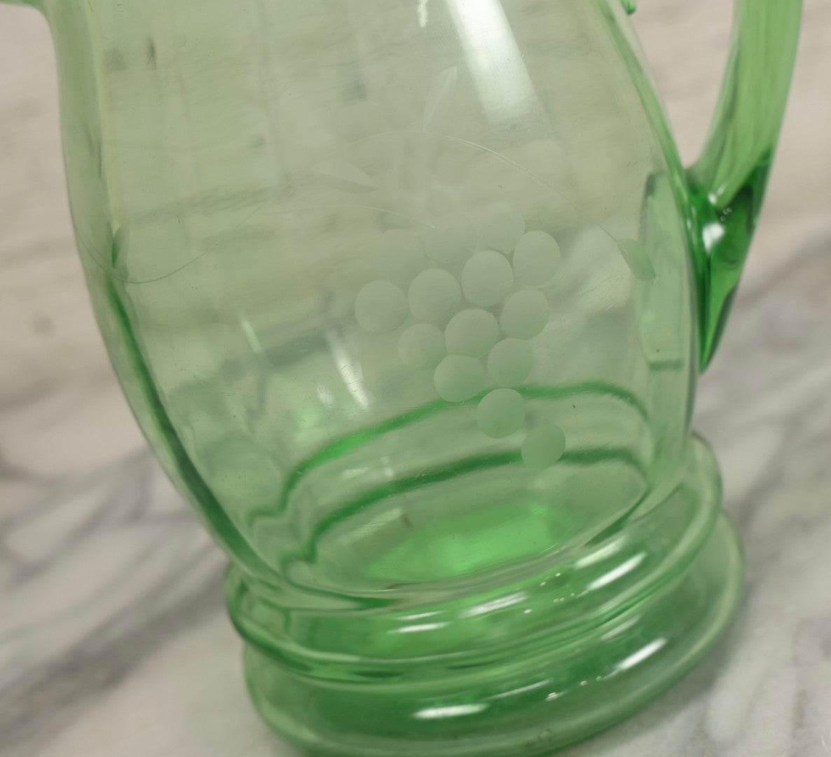 Lot 022 - Antique Uranium Glass Pitcher With Etched Grape Motif, Glows Under Blacklight, Note Chip On Spout
