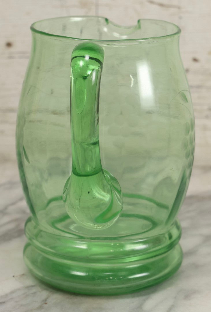 Lot 022 - Antique Uranium Glass Pitcher With Etched Grape Motif, Glows Under Blacklight, Note Chip On Spout