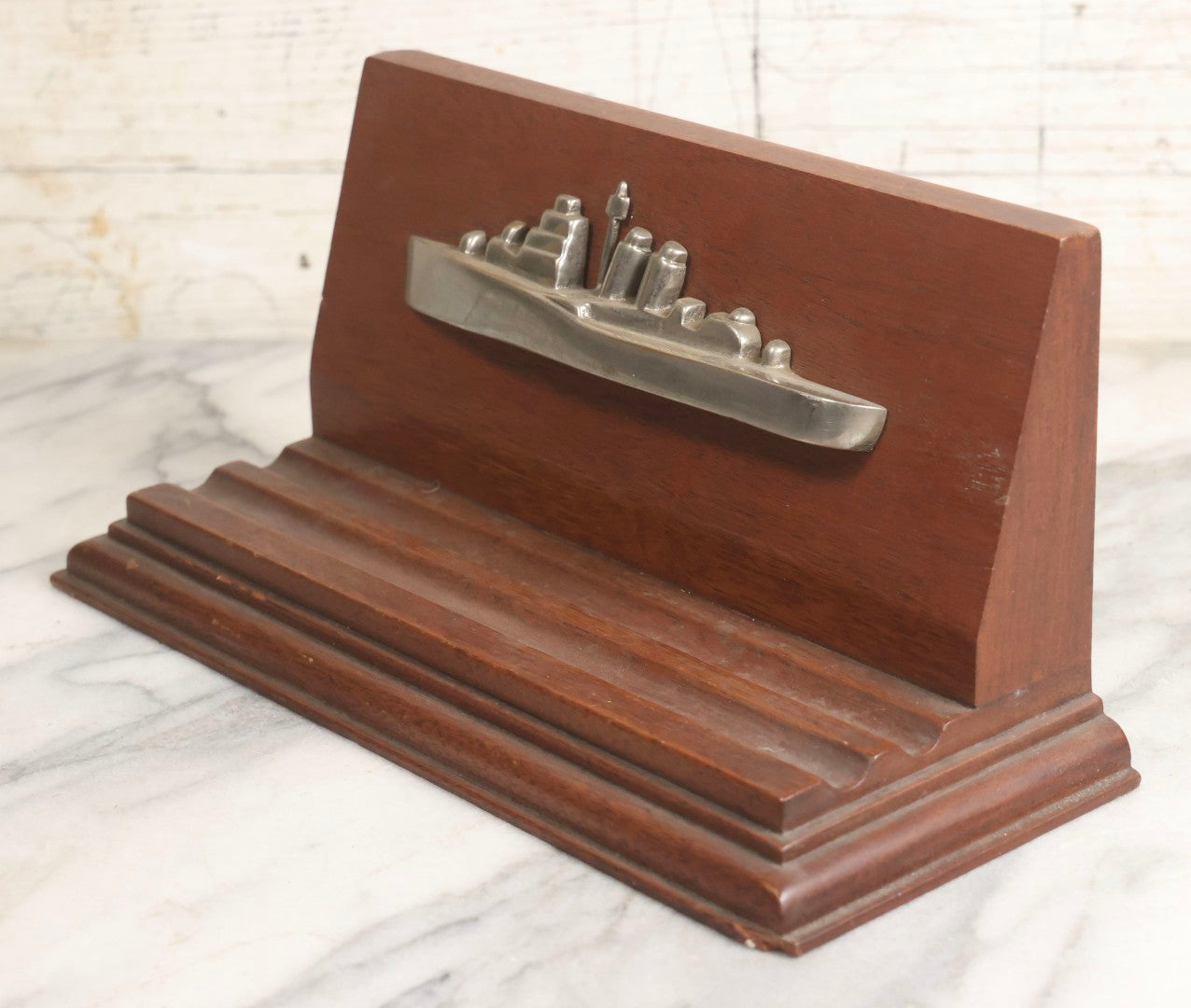 Lot 028 - Vintage U.S. Navy Cruiser Desk Stand Pen Rest With Cast Metal Ship Plaque, Likely Depicting A Baltimore- Or Cleveland-Class WWII Cruiser, Mahogany Base, 11" L