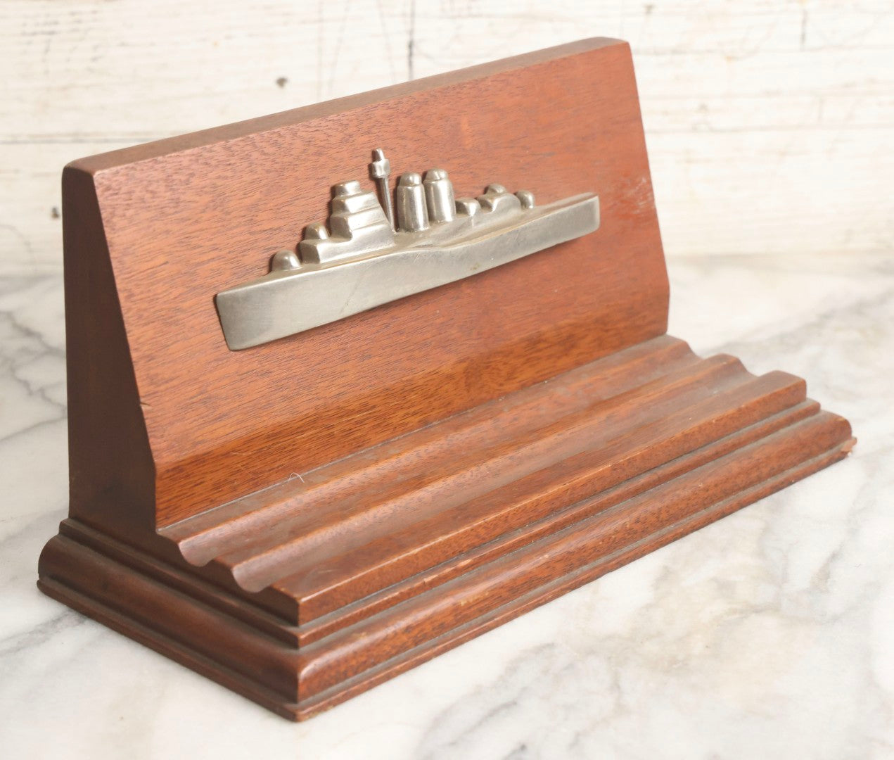 Lot 028 - Vintage U.S. Navy Cruiser Desk Stand Pen Rest With Cast Metal Ship Plaque, Likely Depicting A Baltimore- Or Cleveland-Class WWII Cruiser, Mahogany Base, 11" L