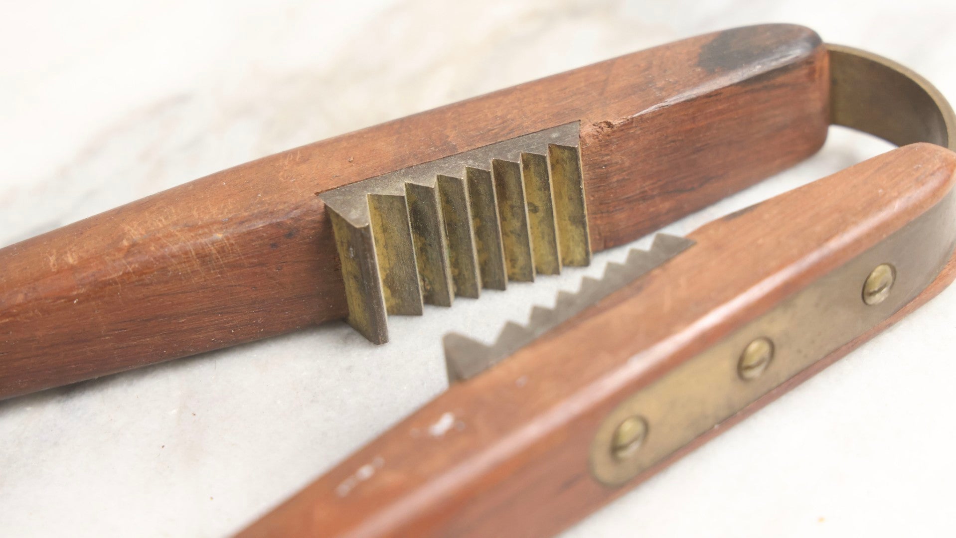 Lot 031 - Antique Wood-Handled Nutcracker With Brass Hardware, Bent Brass Spring Band, And Aggressive Brass Jaws