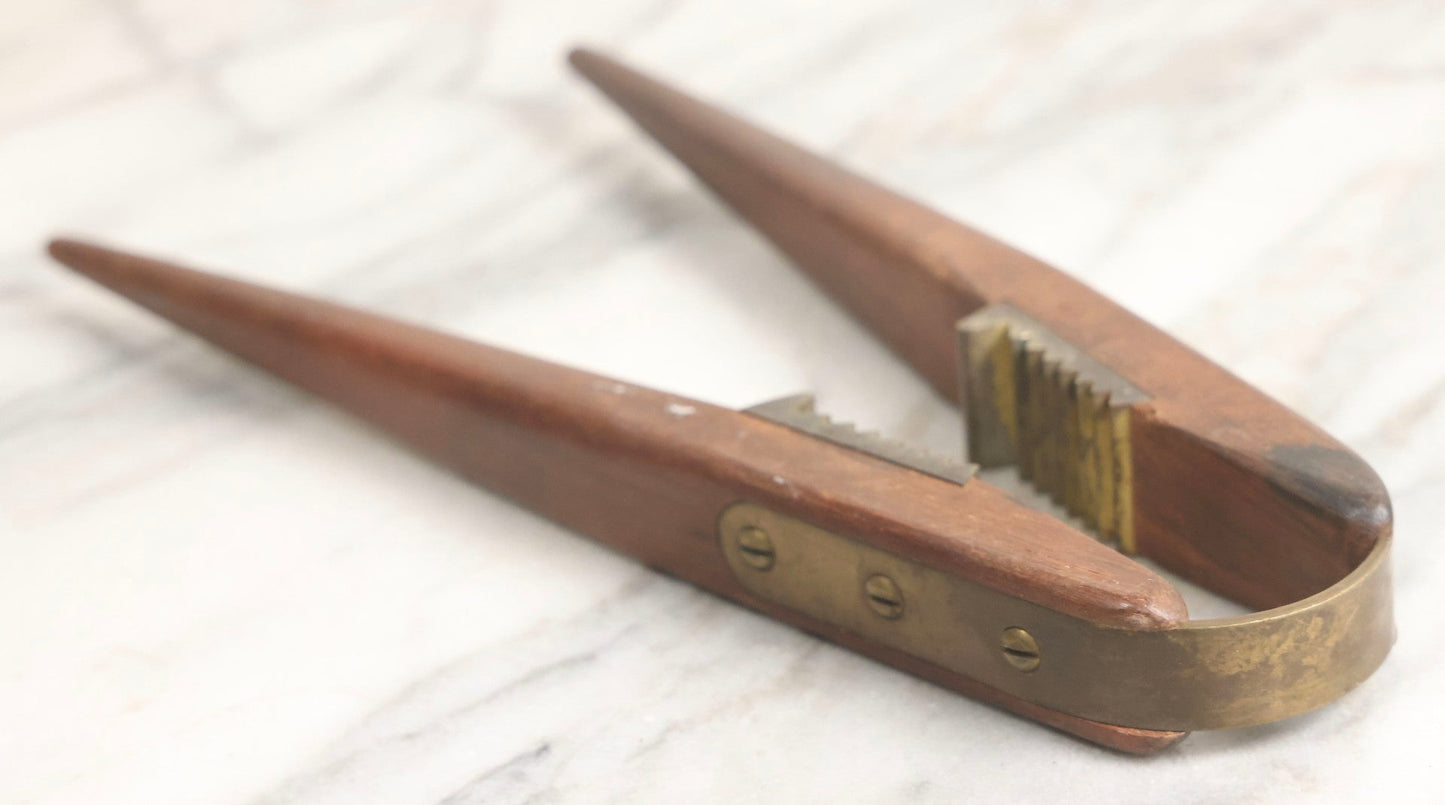 Lot 031 - Antique Wood-Handled Nutcracker With Brass Hardware, Bent Brass Spring Band, And Aggressive Brass Jaws