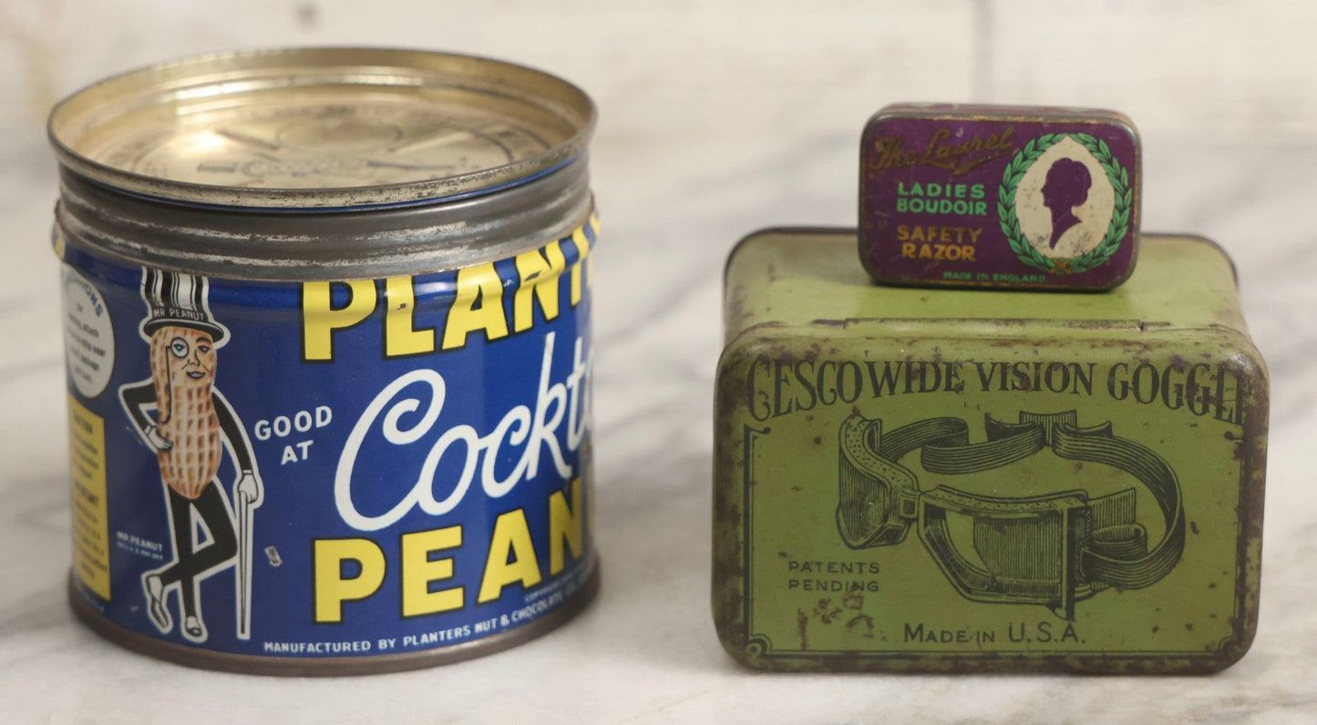 Lot 036 - Trio Of Advertising Tins Including Gescowide Vision Goggles, Laurel Ladies' Boudoir Safety Razor With Contents, And Planters Cocktail Peanuts