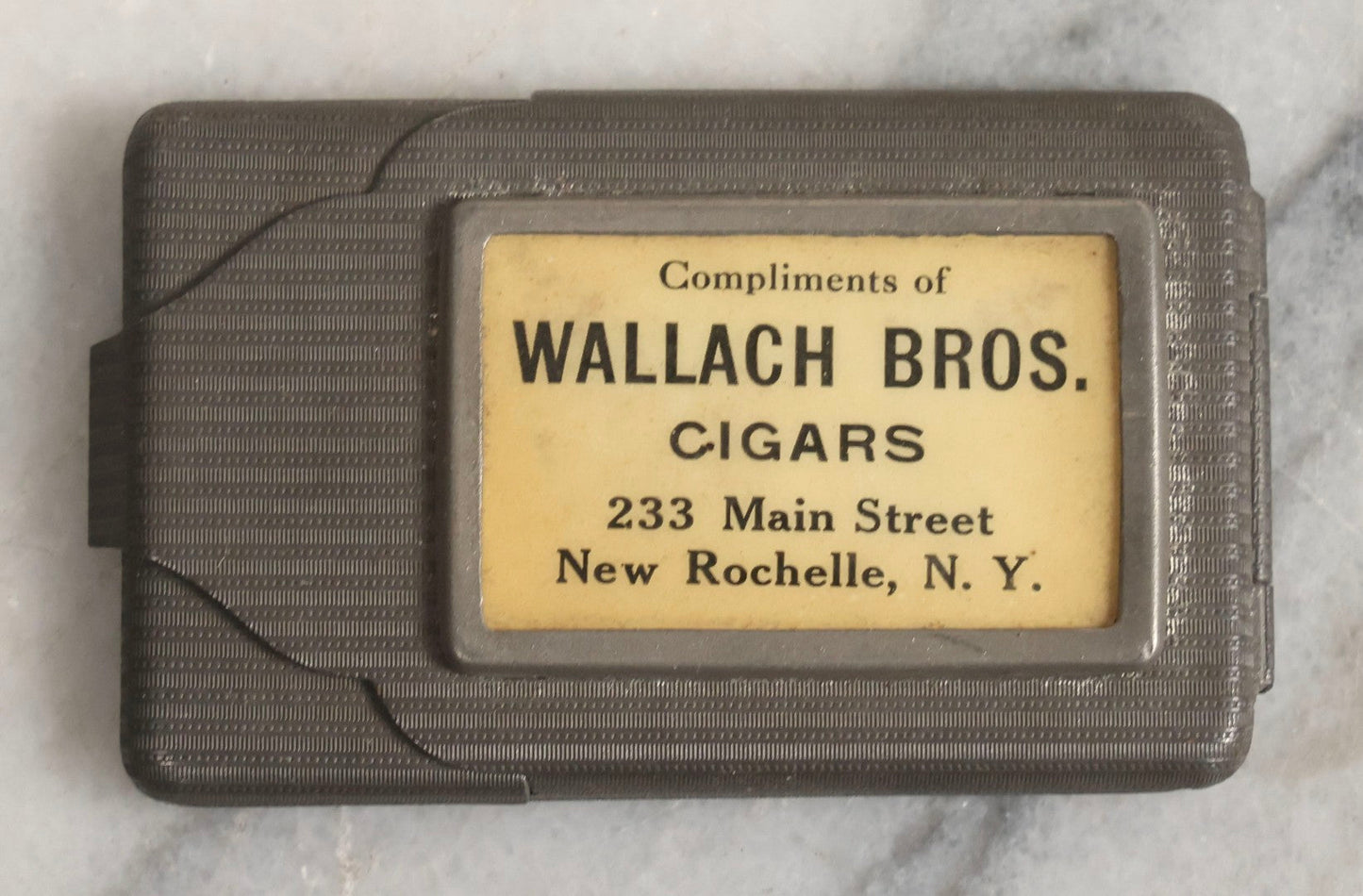 Lot 037 - Antique Pressed Tin Advertising Match Safe, “Compliments Of Wallach Bros. Cigars," 233 Main Street, New Rochelle, New York, Made In Germany