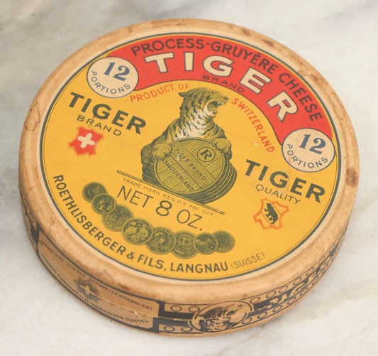 Lot 046 - Vintage Round Paperboard Advertising Box For Tiger Brand Process-Gruyere Cheese, Product Of Switzerland, Manufactured By Roethlisberger & Fils., Langnau (Switzerland), With Dozens Of Tiger Brand Advertising Discs