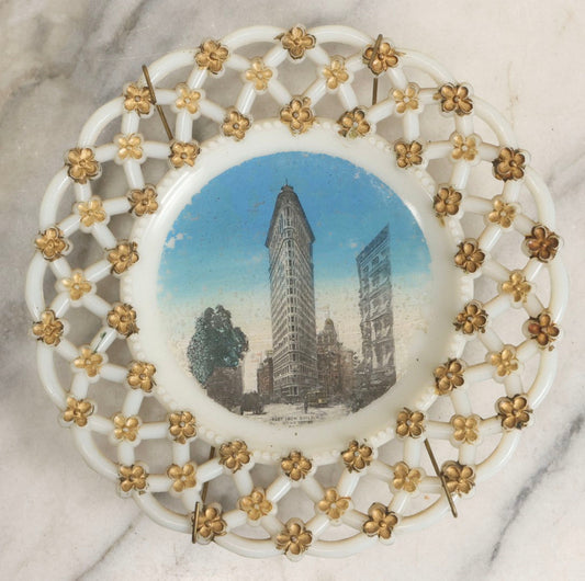 Lot 047 - Antique Milkglass Plate With Lattice Edge And Hand-Colored Transferware Image Of The Flatiron Building, New York City, With Forget-Me-Not Pattern And Brass Plate Hanger