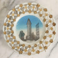 Lot 047 - Antique Milkglass Plate With Lattice Edge And Hand-Colored Transferware Image Of The Flatiron Building, New York City, With Forget-Me-Not Pattern And Brass Plate Hanger, 7-1/2" Diameter