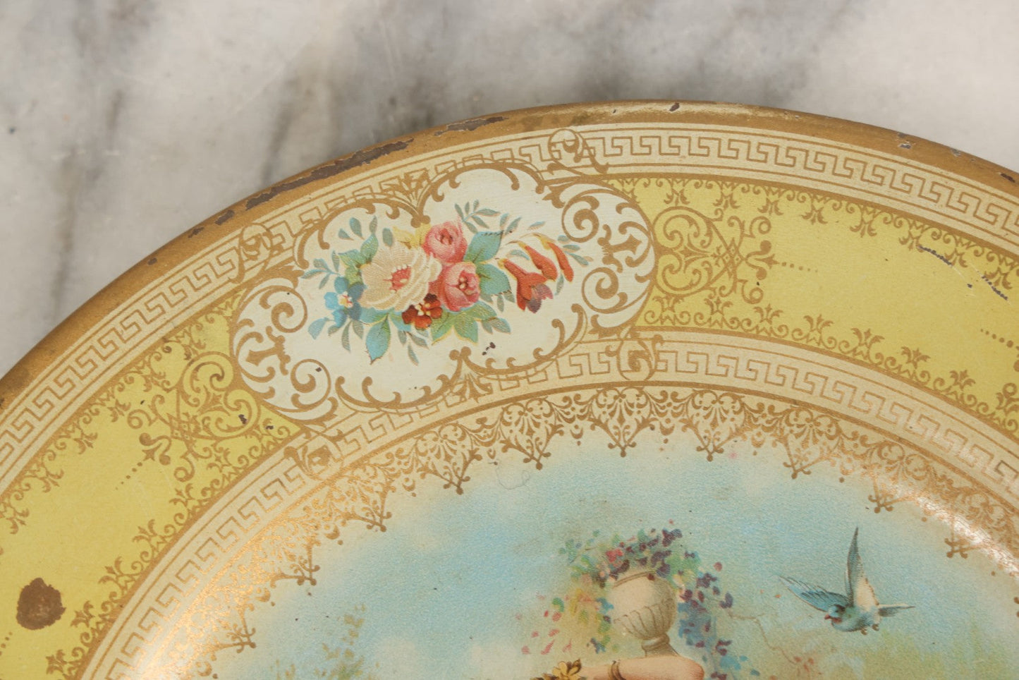Lot 049 - Antique Vienna Art Plates Tin Lithograph Decorative Plate With Classical Maiden, Birds, And Floral Motifs, Marked “Vienna Art Plates, Patent Applied For”