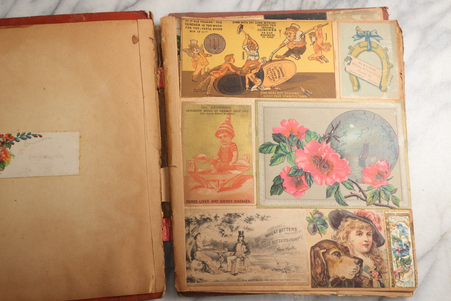 Lot 077 - Antique Red Scrapbook Album With Cat And Birdcage Illustration On Cover, 40+ Pasted Scraps, Victorian Trade Cards, Die Cuts, Loose Ephemera, Rena B. Coggeshalt Name Card, Circa 1875