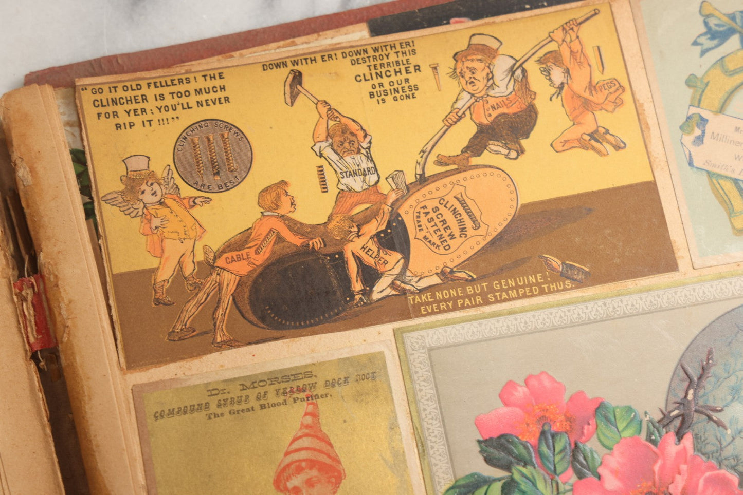 Lot 077 - Antique Red Scrapbook Album With Cat And Birdcage Illustration On Cover, 40+ Pasted Scraps, Victorian Trade Cards, Die Cuts, Loose Ephemera, Rena B. Coggeshalt Name Card, Circa 1875