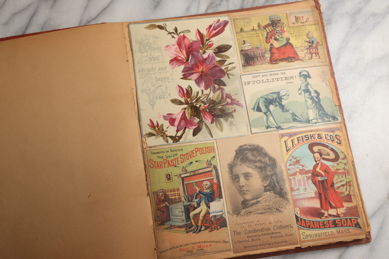 Lot 077 - Antique Red Scrapbook Album With Cat And Birdcage Illustration On Cover, 40+ Pasted Scraps, Victorian Trade Cards, Die Cuts, Loose Ephemera, Rena B. Coggeshalt Name Card, Circa 1875