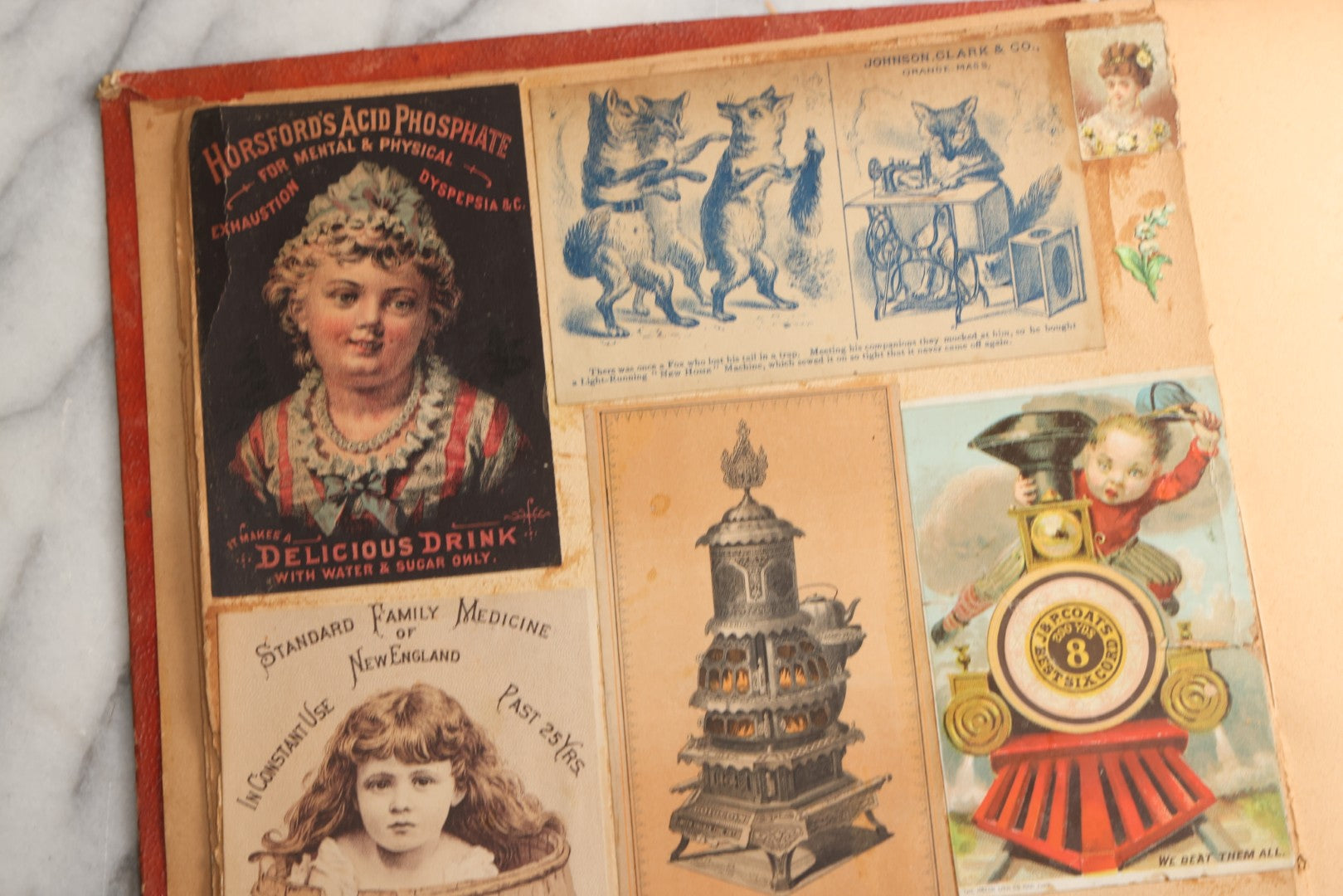 Lot 077 - Antique Red Scrapbook Album With Cat And Birdcage Illustration On Cover, 40+ Pasted Scraps, Victorian Trade Cards, Die Cuts, Loose Ephemera, Rena B. Coggeshalt Name Card, Circa 1875