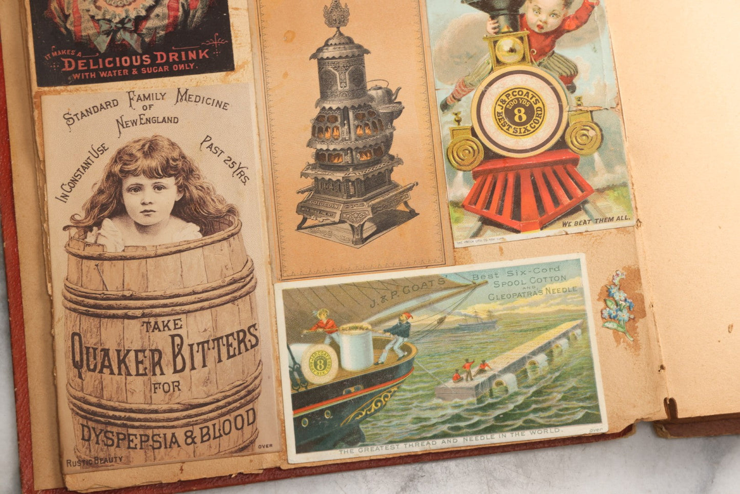 Lot 077 - Antique Red Scrapbook Album With Cat And Birdcage Illustration On Cover, 40+ Pasted Scraps, Victorian Trade Cards, Die Cuts, Loose Ephemera, Rena B. Coggeshalt Name Card, Circa 1875