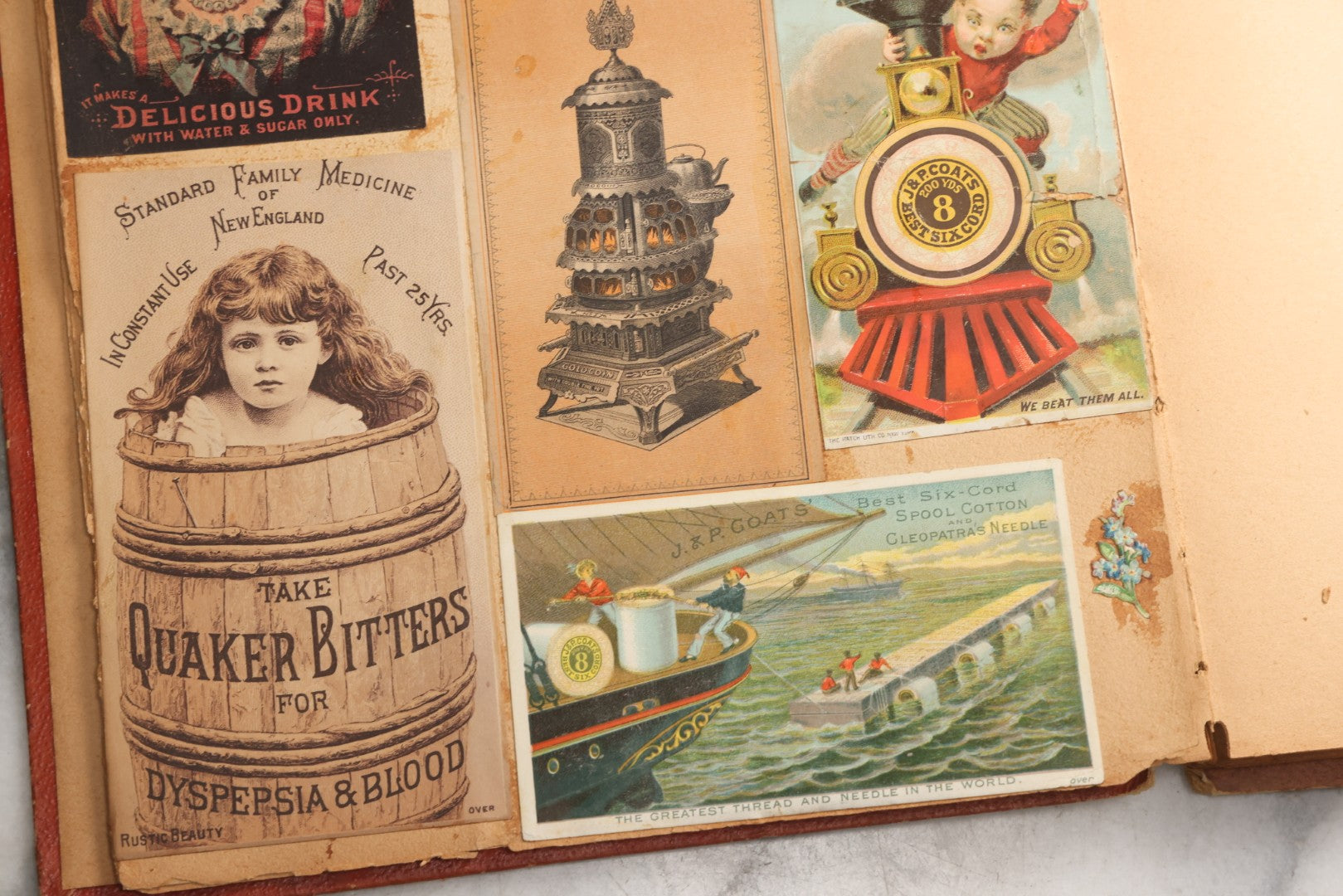 Lot 077 - Antique Red Scrapbook Album With Cat And Birdcage Illustration On Cover, 40+ Pasted Scraps, Victorian Trade Cards, Die Cuts, Loose Ephemera, Rena B. Coggeshalt Name Card, Circa 1875