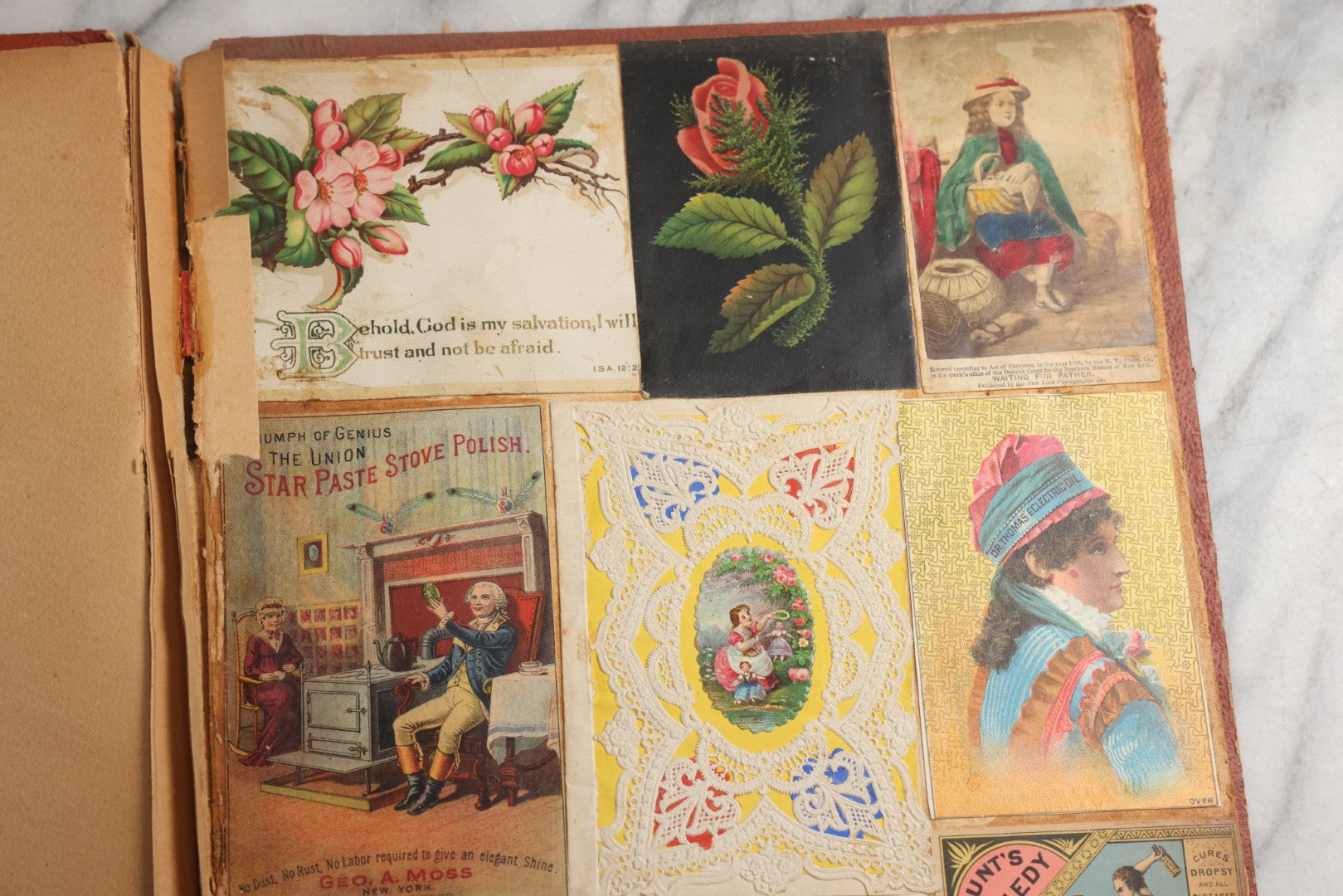 Lot 077 - Antique Red Scrapbook Album With Cat And Birdcage Illustration On Cover, 40+ Pasted Scraps, Victorian Trade Cards, Die Cuts, Loose Ephemera, Rena B. Coggeshalt Name Card, Circa 1875