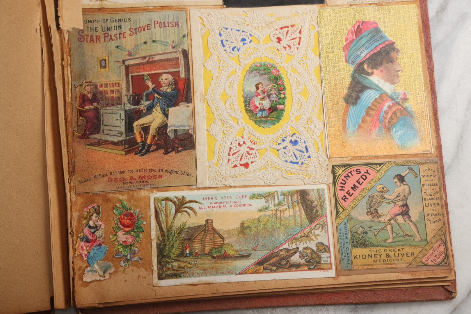 Lot 077 - Antique Red Scrapbook Album With Cat And Birdcage Illustration On Cover, 40+ Pasted Scraps, Victorian Trade Cards, Die Cuts, Loose Ephemera, Rena B. Coggeshalt Name Card, Circa 1875