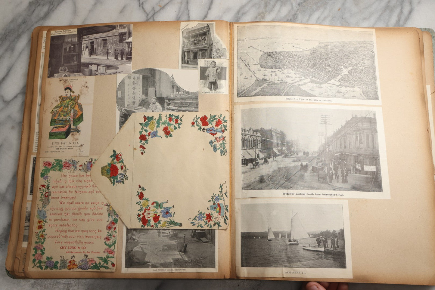 Lot 080 - Antique Light Blue Scrapbook Album With Silver Painted Embossed Decorations, California, San Francisco Chinatown, Oakland, Yosemite Ephemera, Homemade Herbarium With Location Captions Including Yellowstone Park And Utah, Circa 1897