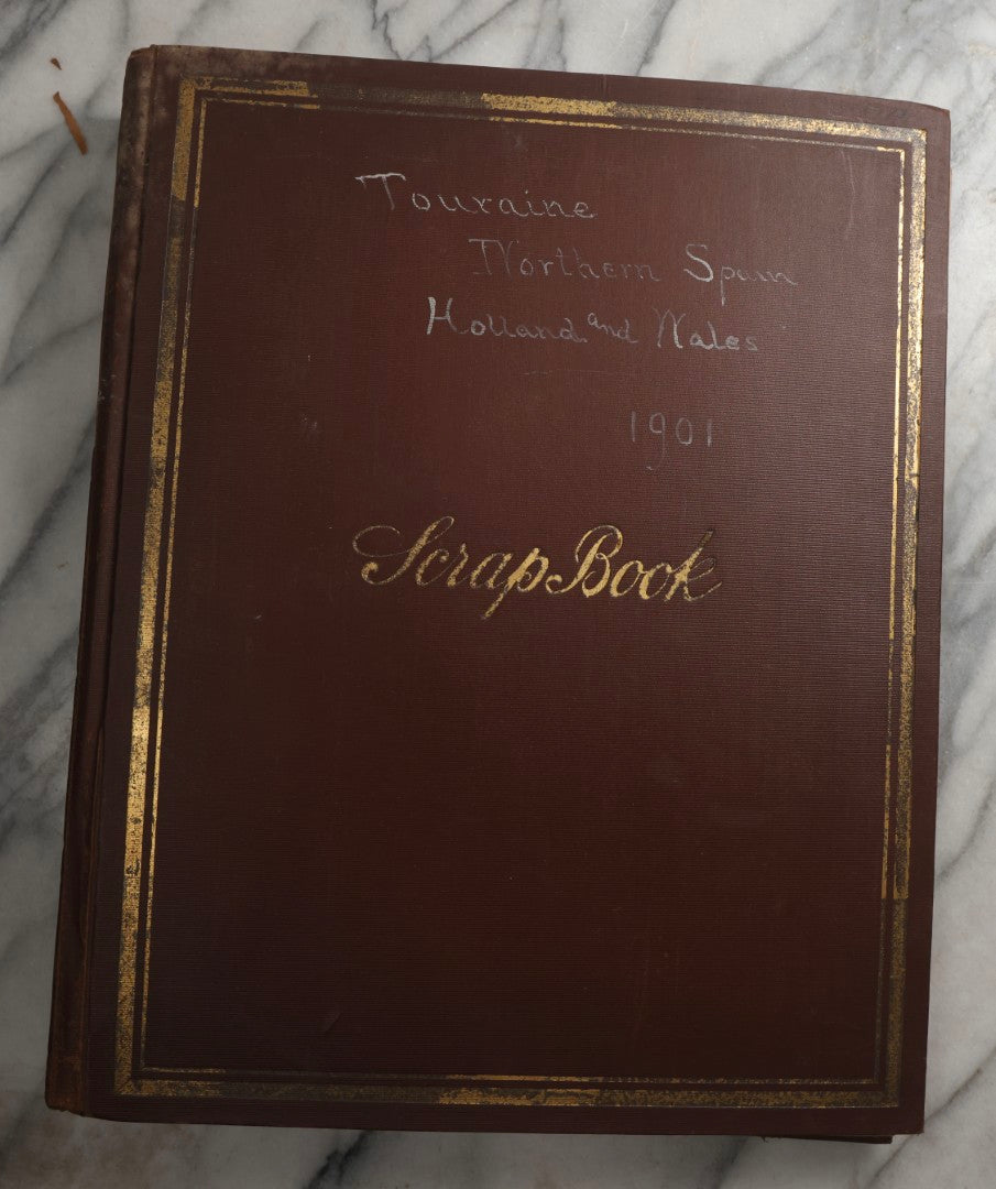 Lot 082 - Antique Brown Scrapbook Album With Gold Borders, European Travel Ephemera Including Touraine, Northern Spain, Holland, Wales, Thomas Cook Tickets, Hotel Menus, Postcards, Pressed Flowers, Circa 1901